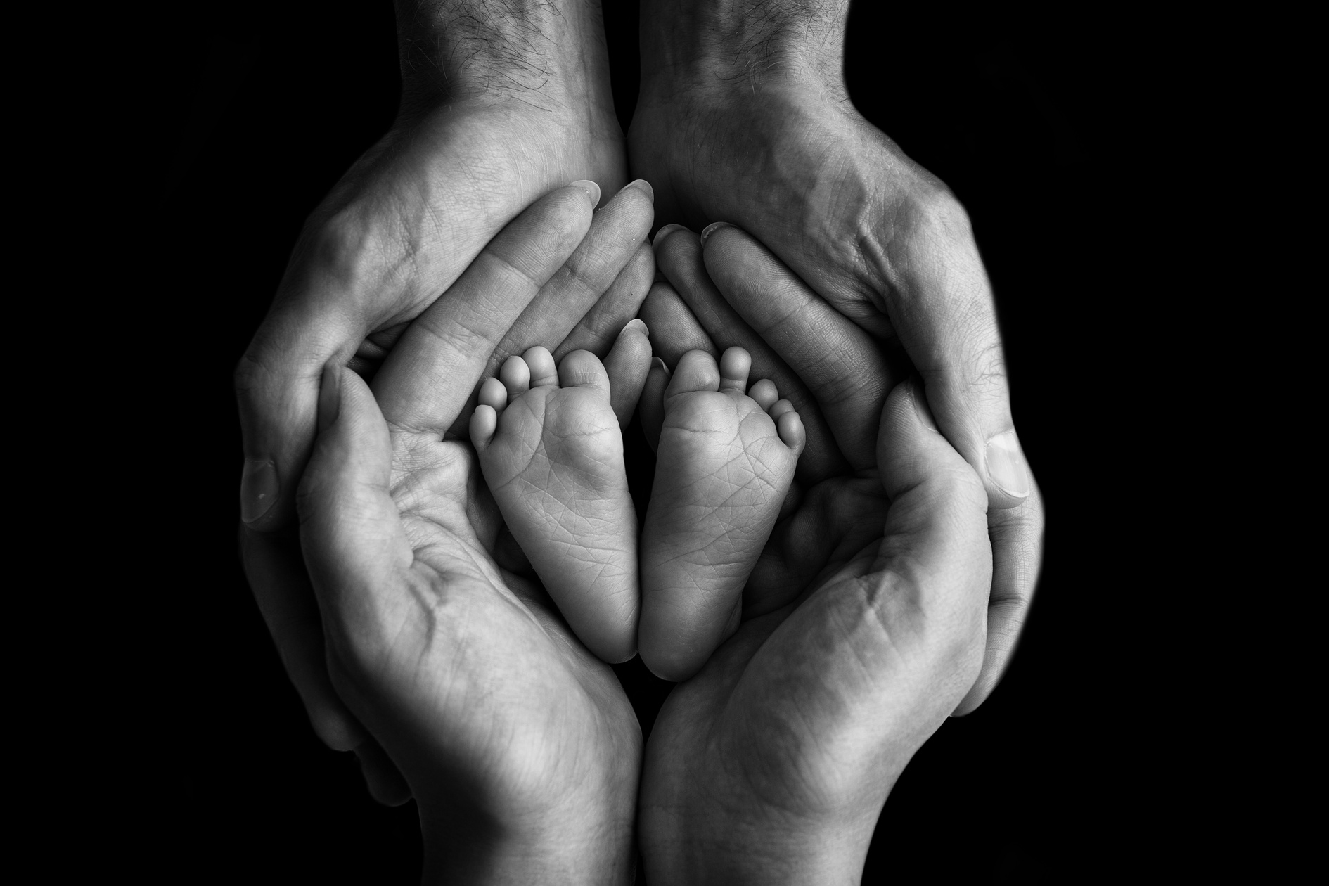 Baby's Feet on Parents' Hands